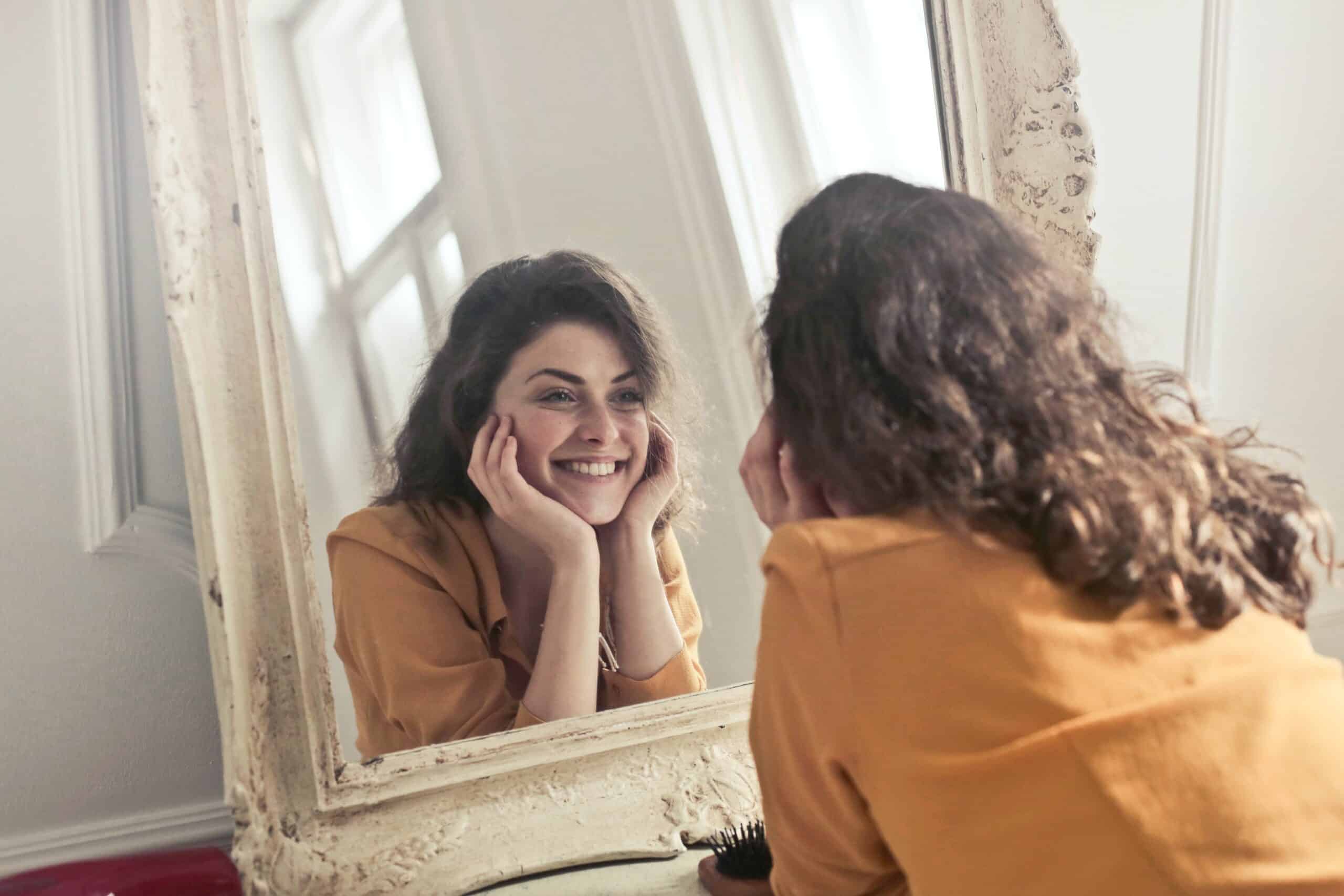 Woman Smiling in Mirror, Same Day Implants